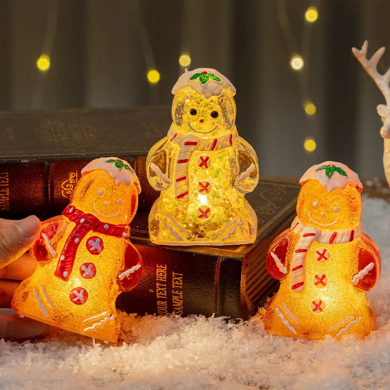 Set of four glowing plastic Christmas ornaments: gingerbread men and snowmen with red, white, and transparent scarves.