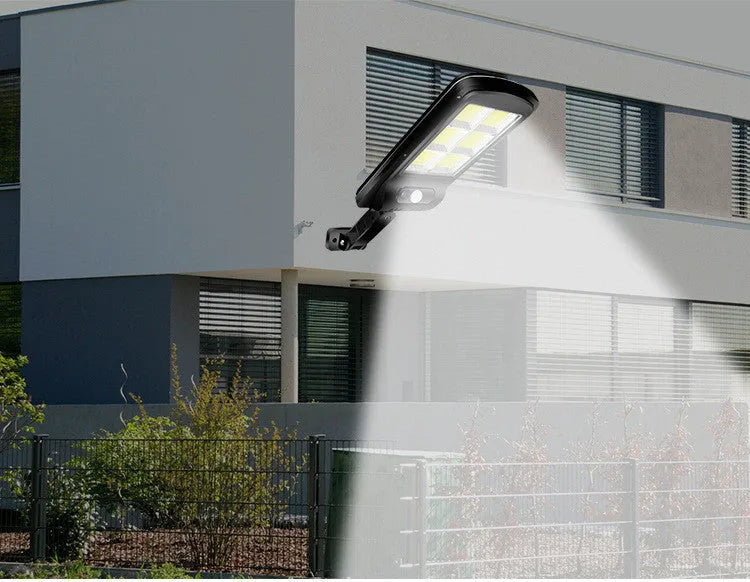 Black solar motion sensor light for outdoor garden and security lighting with PIR detection