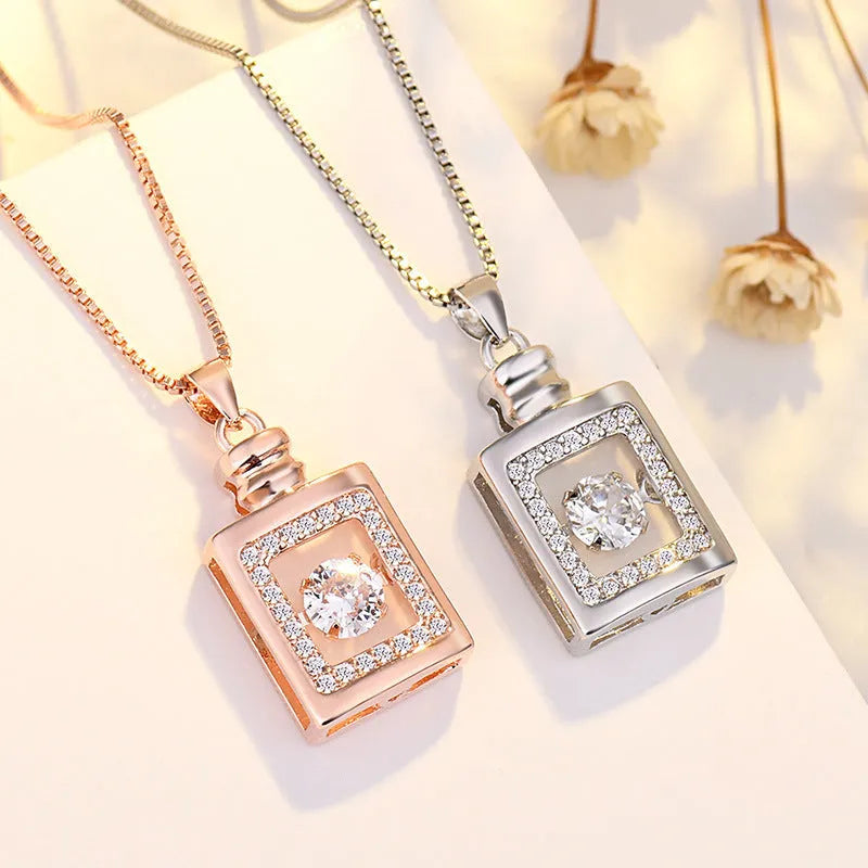 Sterling silver heart-shaped pendant necklace with crown and bow details on an adjustable chain.