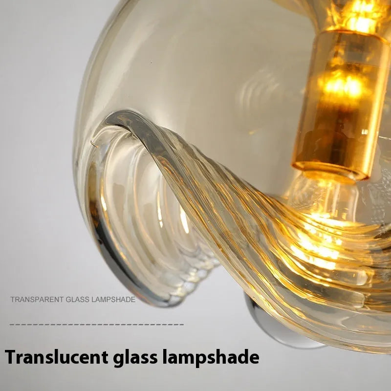 Modern glass chandelier with minimalist design showing transparent, amber and smoky grey light colour options