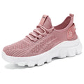 Women's white Flyknit running sneakers with thick PVC sole and lace-up front on a beige background.