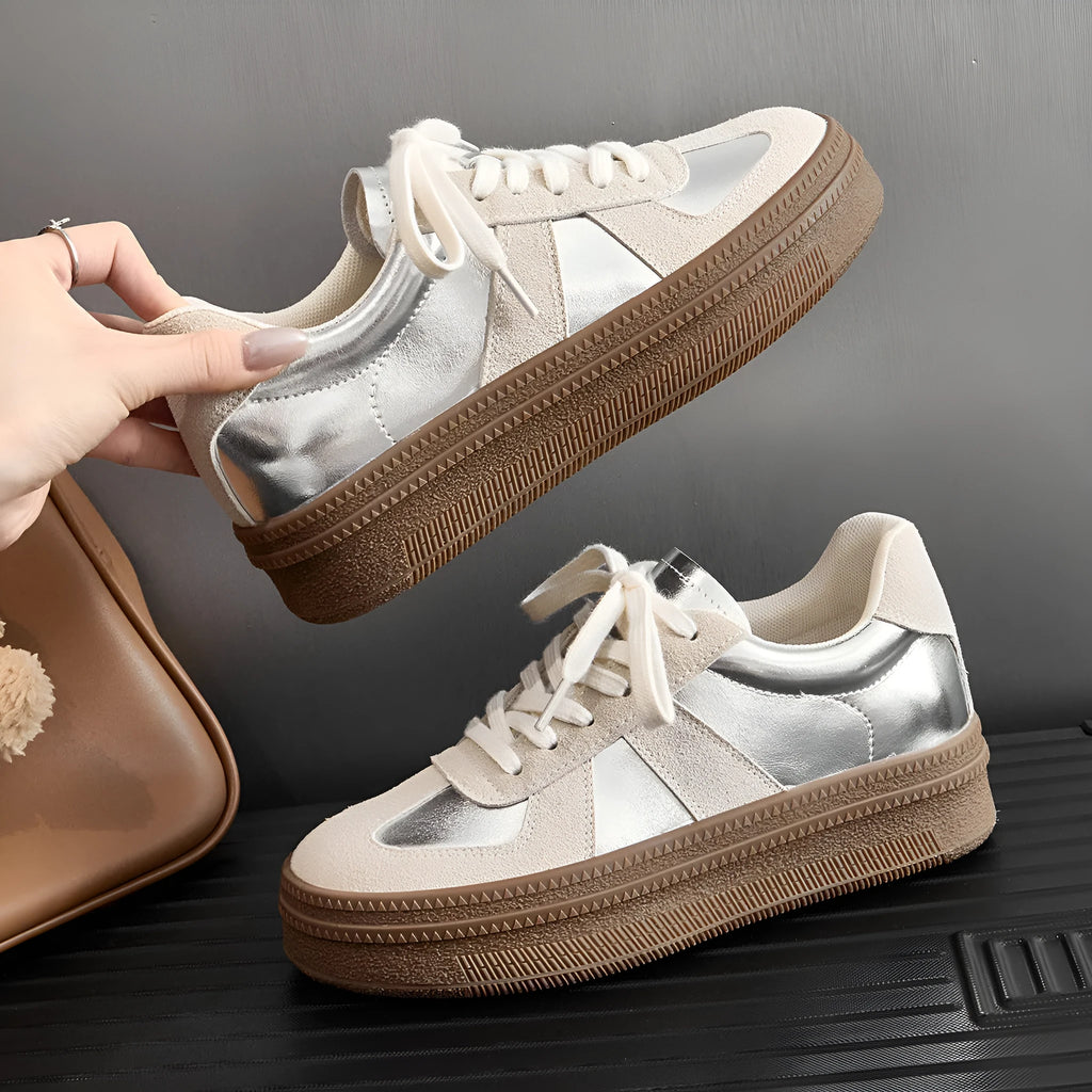 Retro-style silver board shoes with cross straps and round toe on a rubber sole.