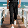 Men's loose-fit linen trousers in light khaki colour with a drawstring waistband.