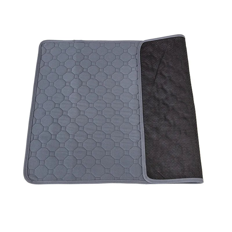 Two neutral-coloured washable dog pee pads, one tan and one grey, showing textured fabric surface.