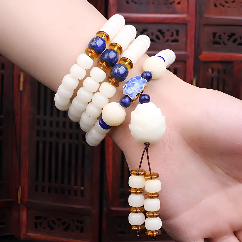 White jade Bodhi bead long bracelet with 6x8mm beads in various styles including cloisonne and tassel designs.