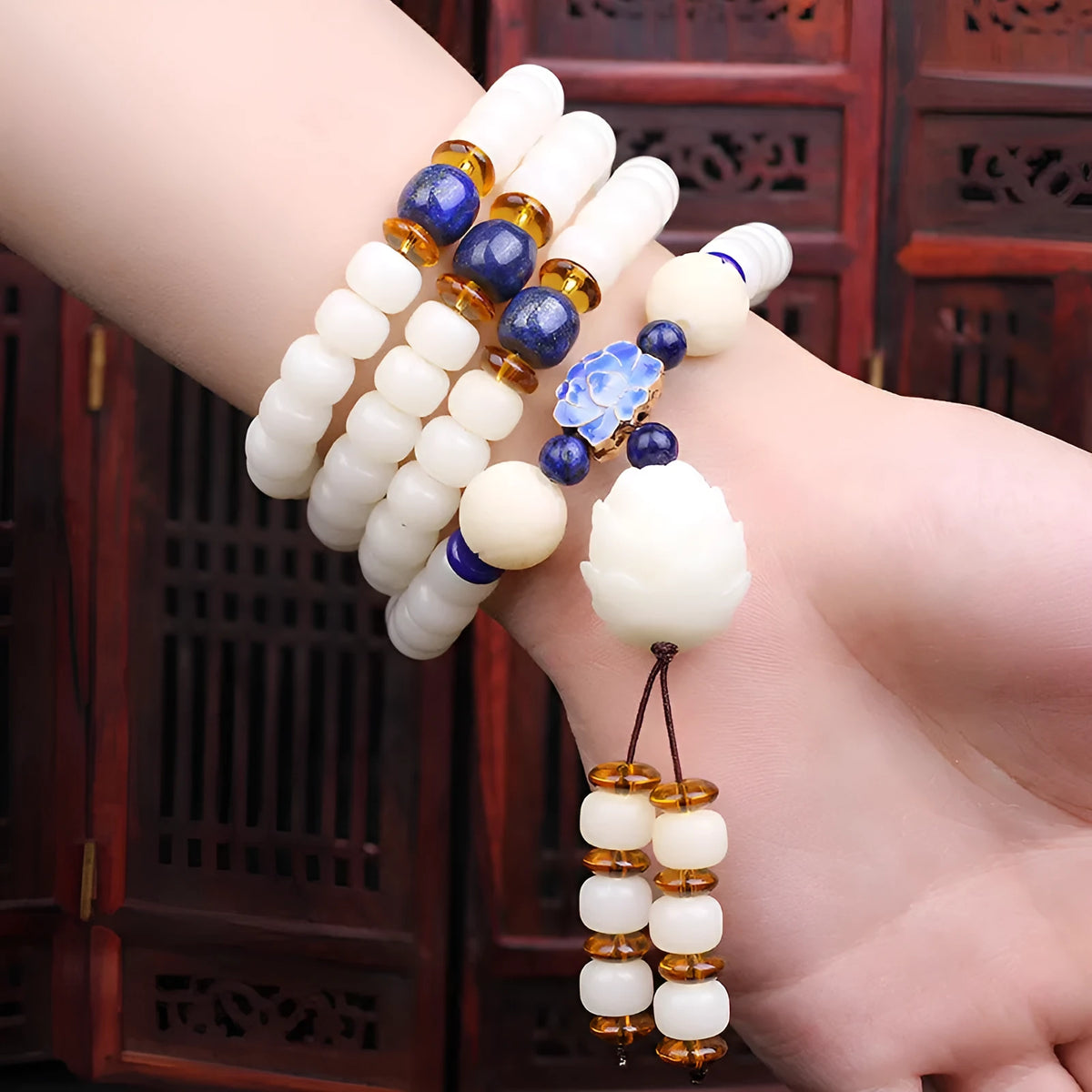 White jade Bodhi bead long bracelet with 6x8mm beads in various styles including cloisonne and tassel designs.
