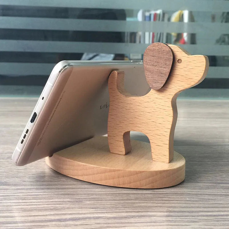 Solid beech wood mobile phone stand with a decorative resin animal ornament and a coin slot.