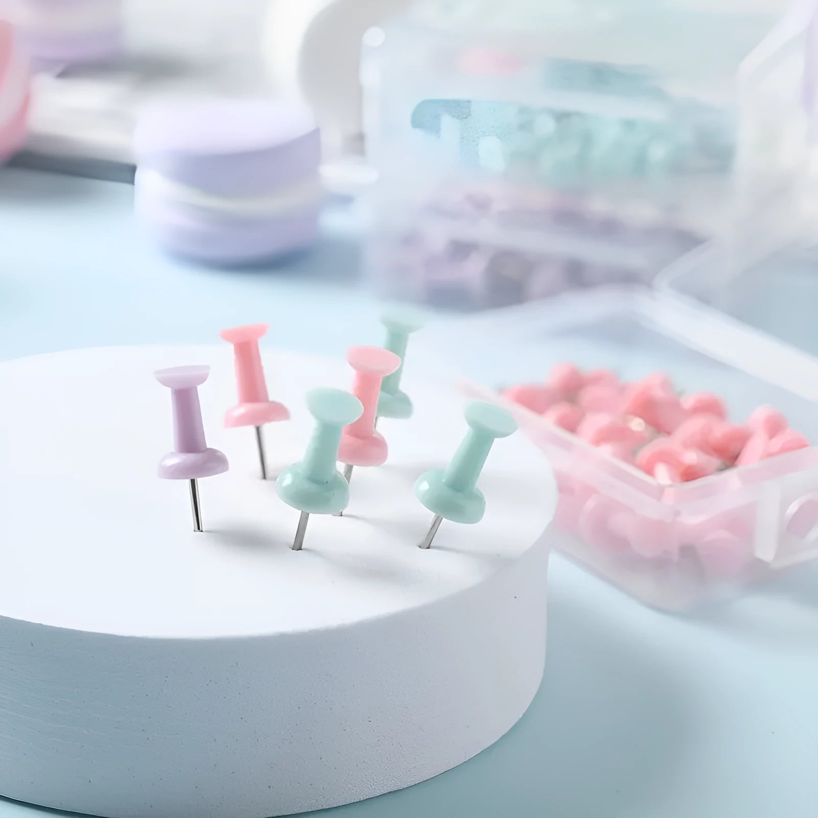 Box of colourful plastic push pins in cherry blossom pink, mint green and lavender macaron colours