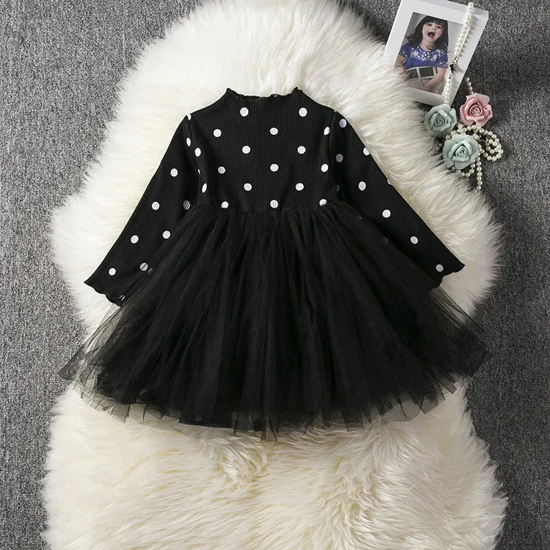 Baby girl wearing a long sleeve white lace tutu dress for a birthday party