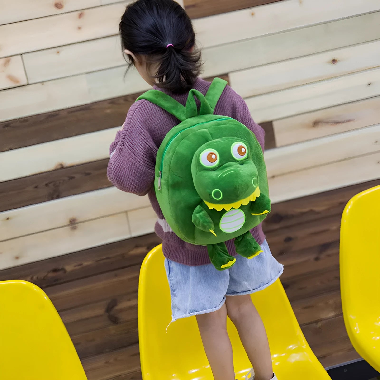 Blue dinosaur plush backpack with embroidery details and soft handle