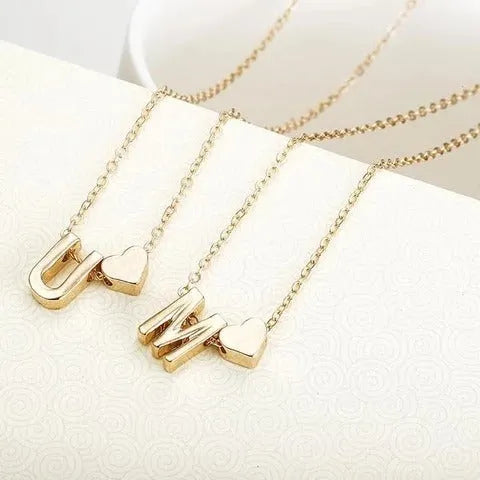 Peach-shaped heart letter pendant necklace on a chain in a gold or silver alloy finish.
