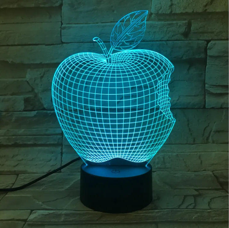 3D fruit-shaped colourful LED night light with touch control on a surface