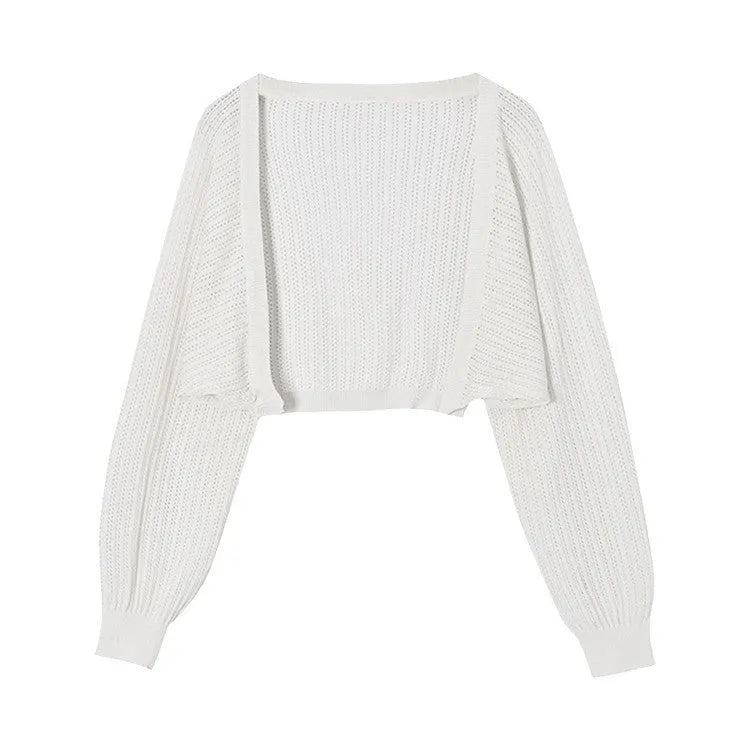 Women's white blouse with long, loose lantern sleeves featuring hollow-out details.