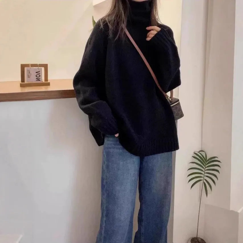 Women's loose thick turtleneck sweater with a curled pile collar in a solid colour.
