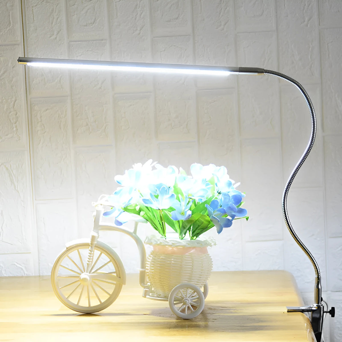 Silver LED clip-on table lamp with long adjustable arm for nail lighting and detailed work