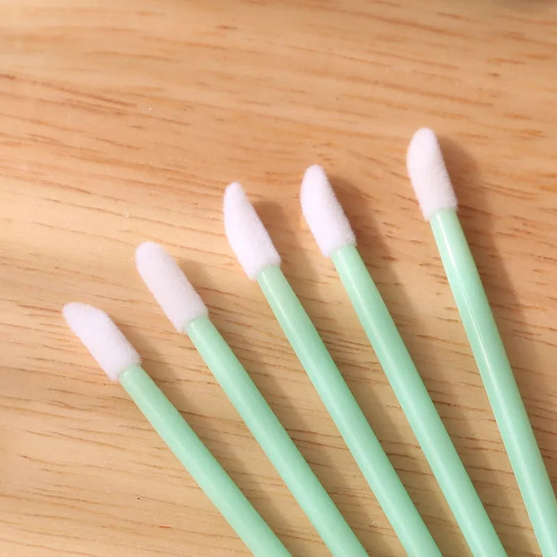 Disposable lip brushes with flocked tips and black handles in multiple colours