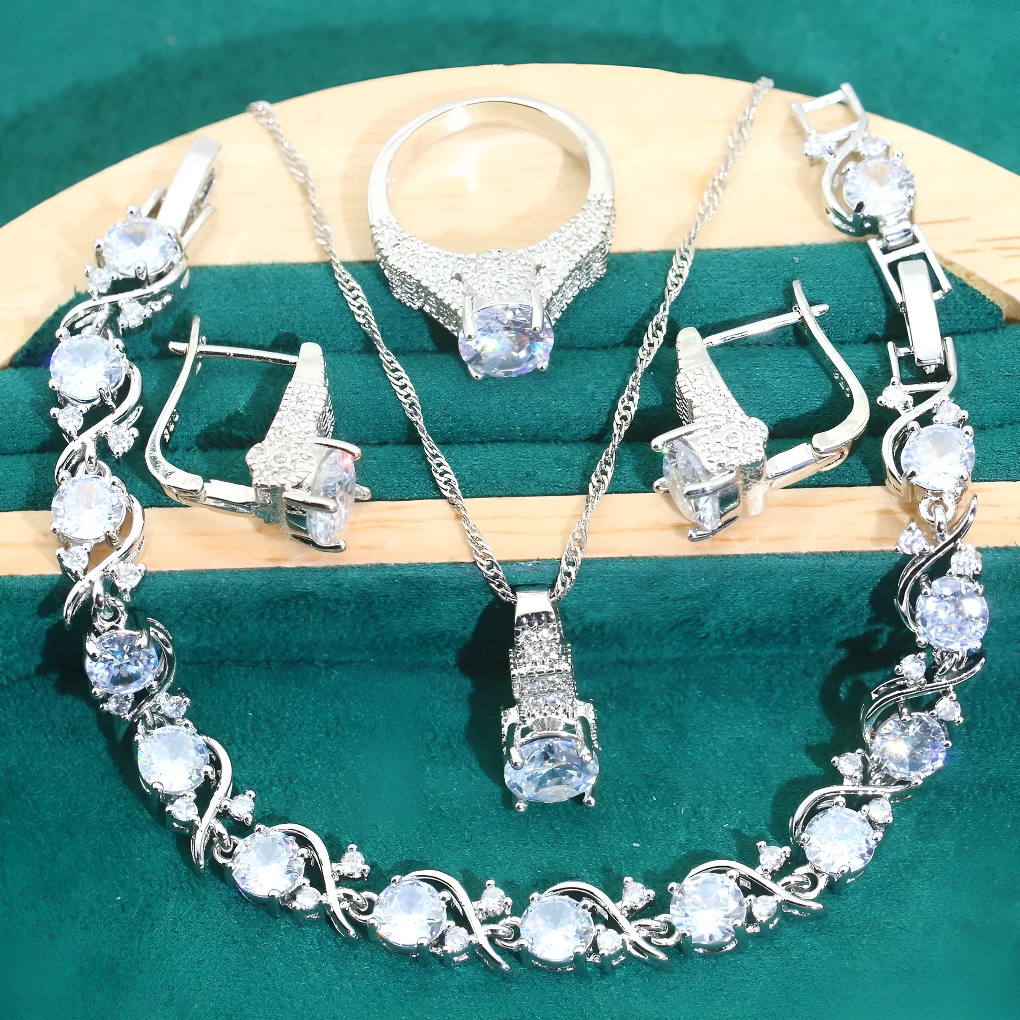 Bridal four-piece zircon jewellery set showing necklace, bracelet, earrings, and ring in alloy with water wave chain.