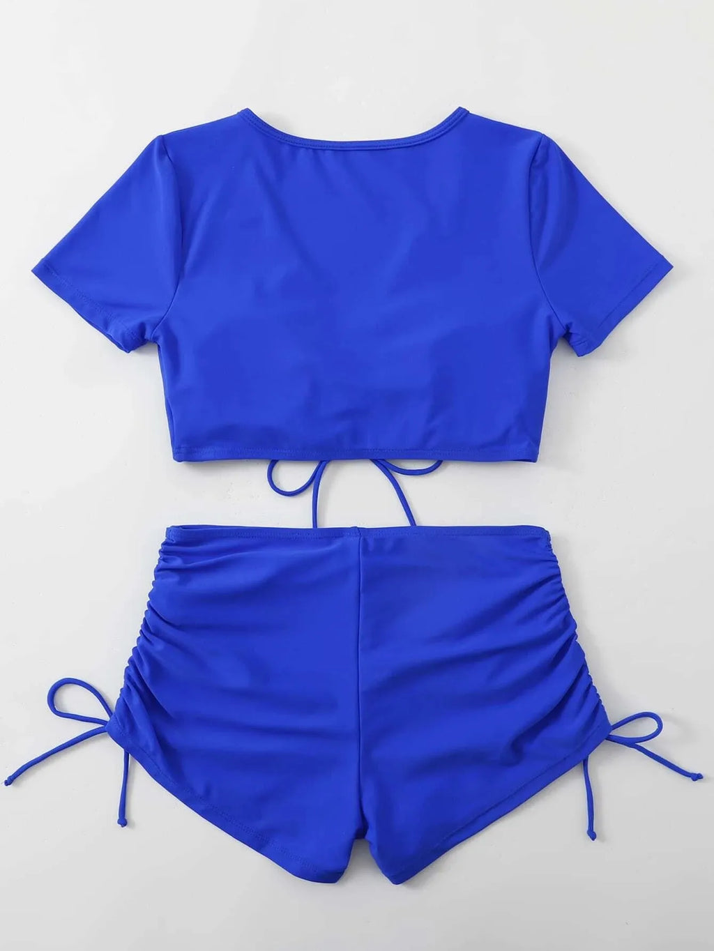 Women's dark green lace-up swimsuit top and shorts with a bow detail