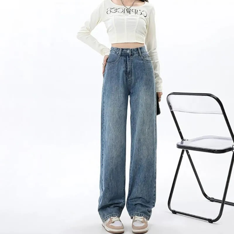 A woman wearing high-waisted retro blue wide-leg jeans made from stretch denim.