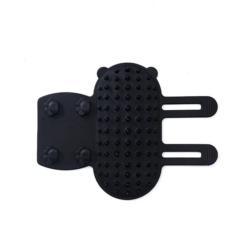 Adjustable silicone cat scratching grooming brush in black, mounted on a table leg.