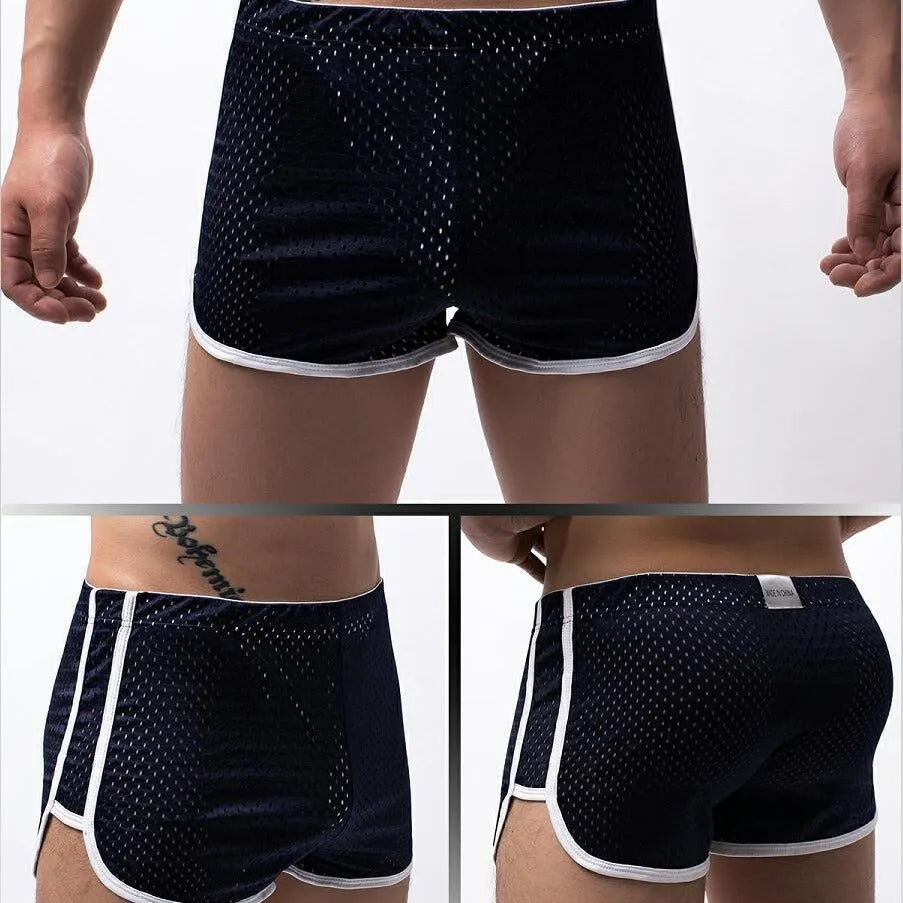 Men's grey three-point cotton boxer shorts laid flat, showing mid-waist and knitted fabric.