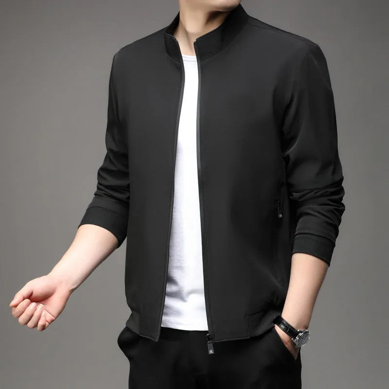 Man wearing a loose-fit black Korean-style autumn jacket with a lapel collar and zipper pockets.