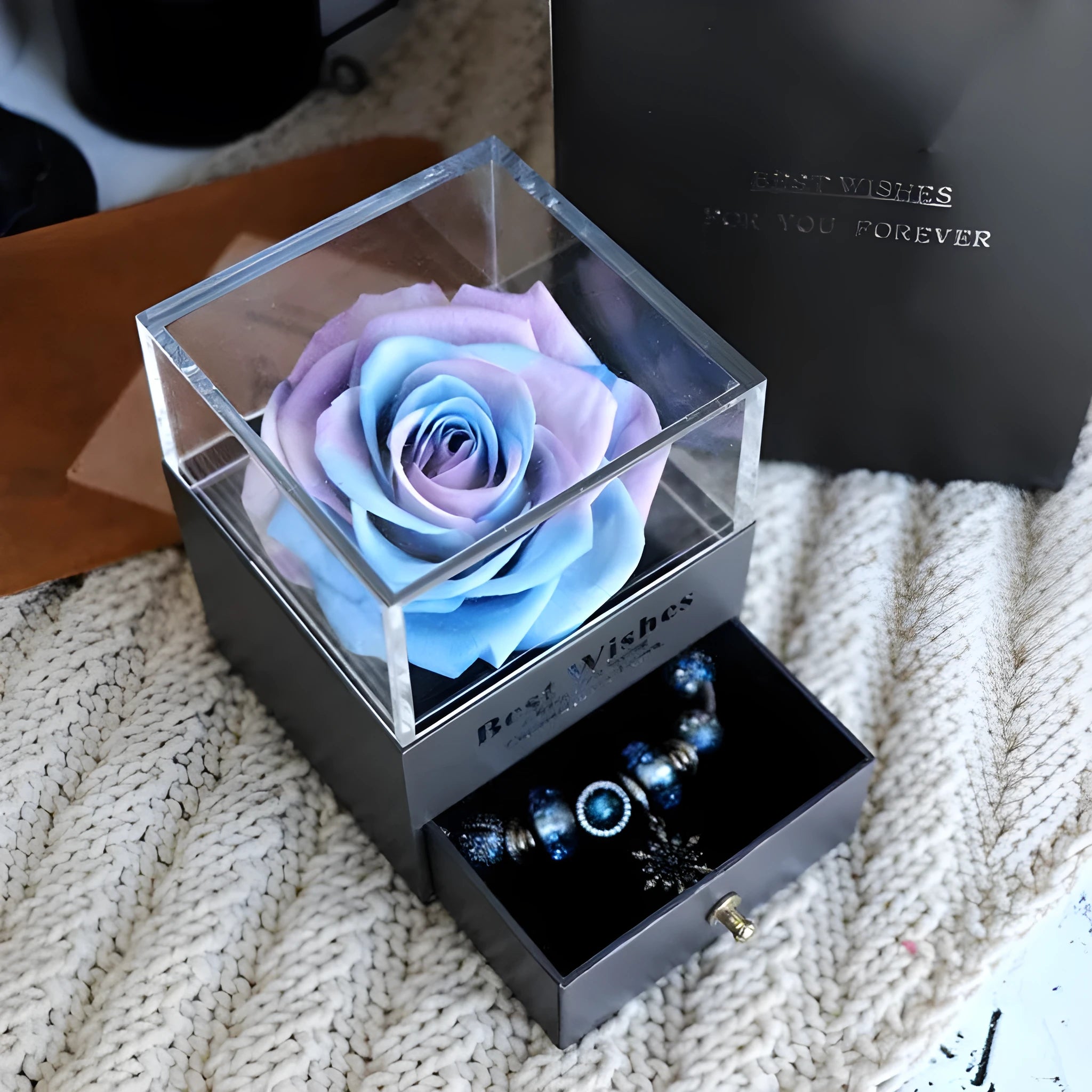 Glass eternal flower jewellery box with preserved roses and carnations inside measuring 8.5cm square