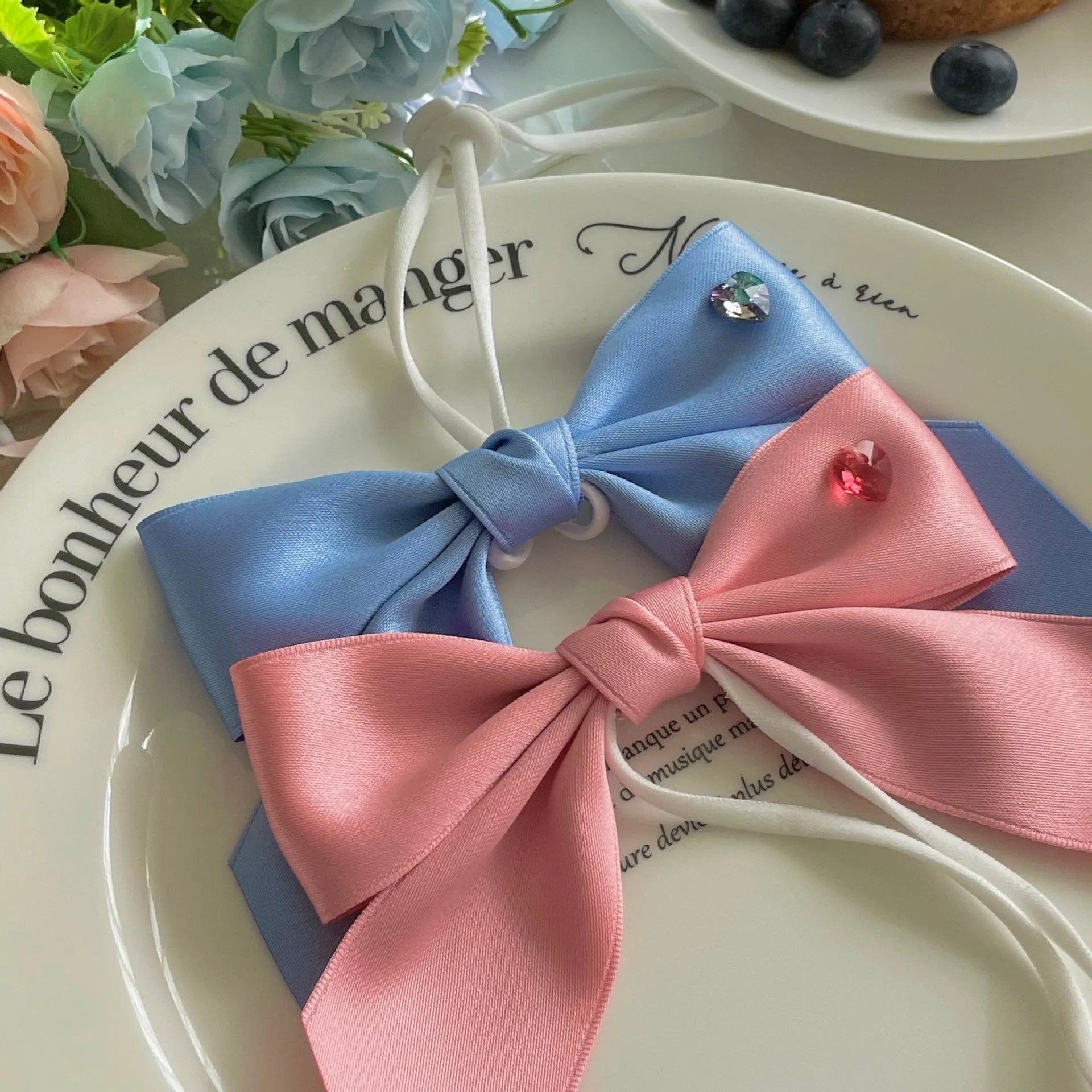 Blue princess-style dog hair band with adjustable bow on canine model