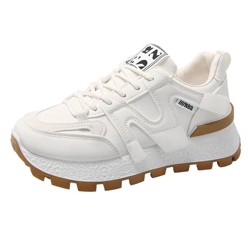 Pair of low-top unisex casual sneakers in black or white with round toe and front lace-up closure.
