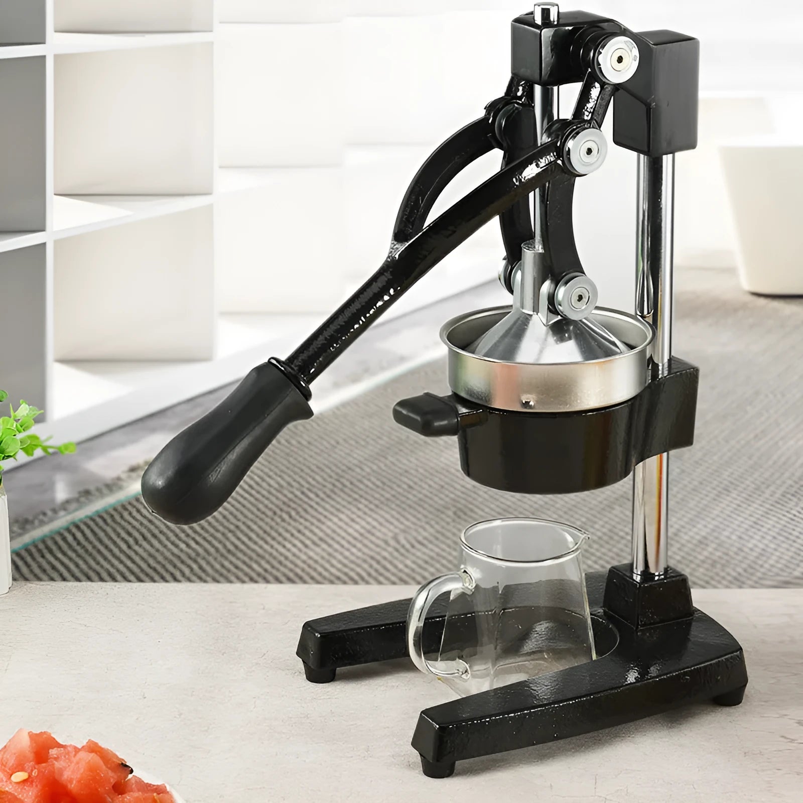 Black cast iron manual citrus juicer with stainless steel strainer, 40cm tall