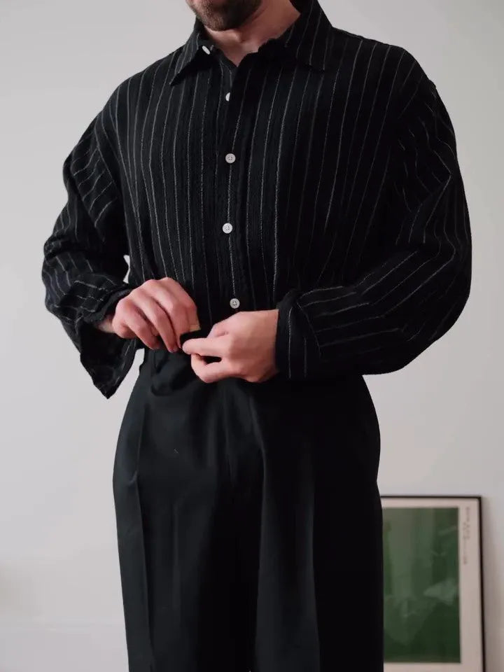 Black pinstriped polyester button-down shirt on a hanger showing regular fit