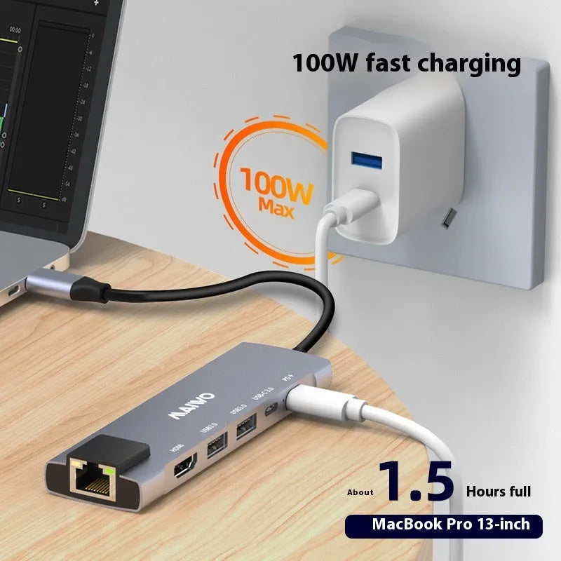 Steam Deck six-in-one aluminium docking station with HDMI, USB, and ethernet ports on a desk.