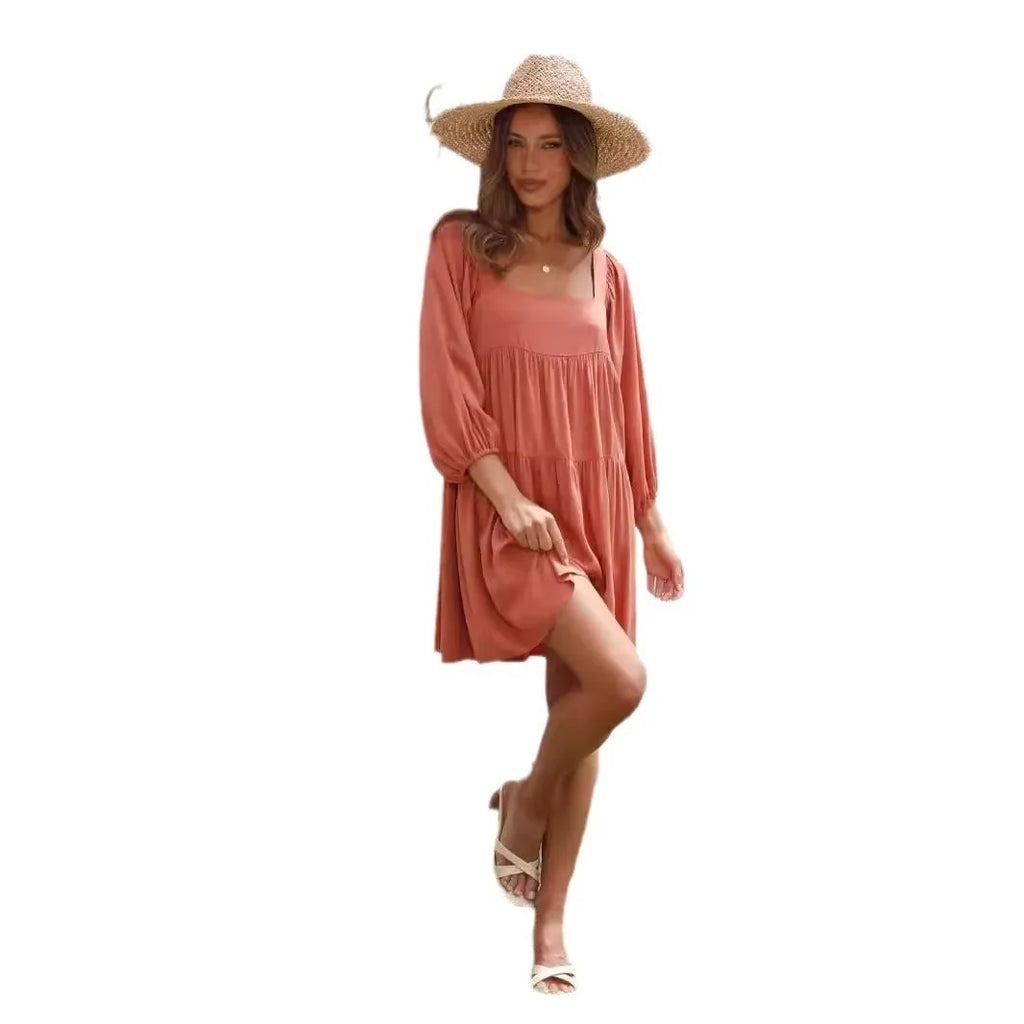 Girls orange backless dress with puff sleeves and a square collar, showing A-line skirt.