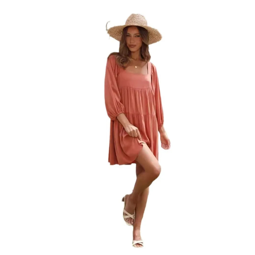Girls orange backless dress with puff sleeves and a square collar, showing A-line skirt.