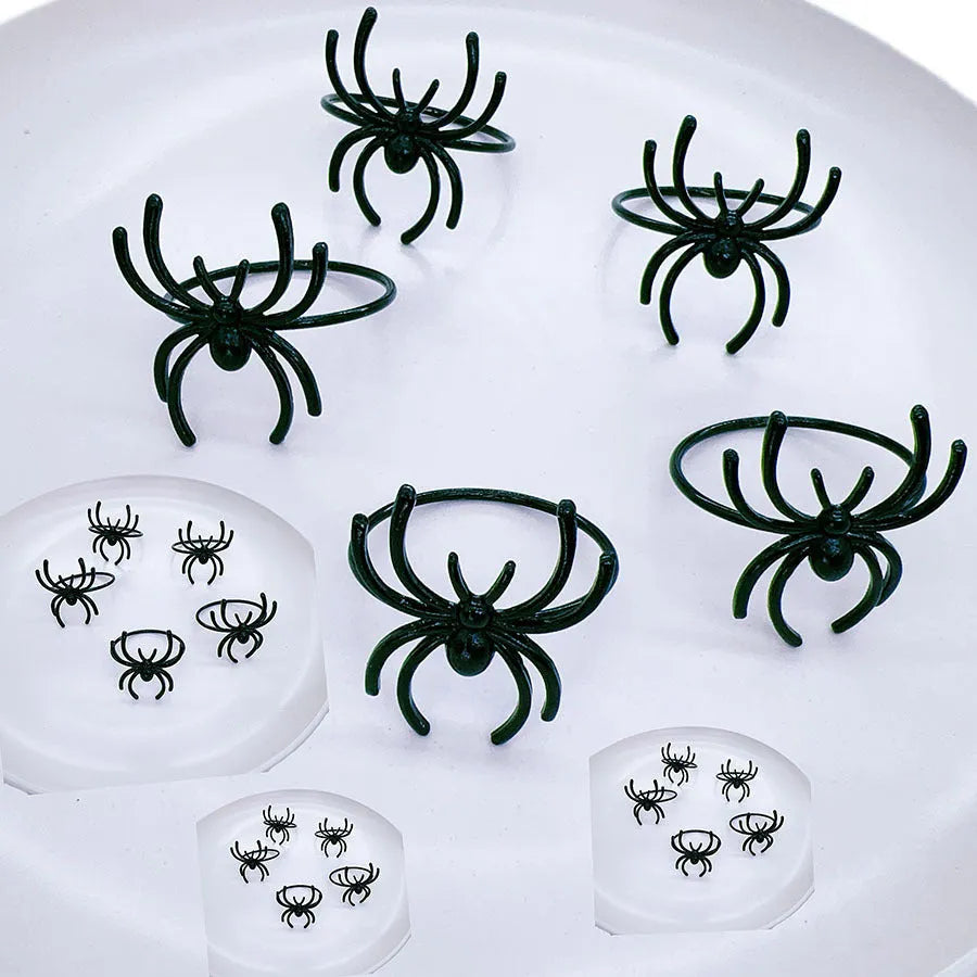Six black spider-design alloy napkin rings for Halloween table settings