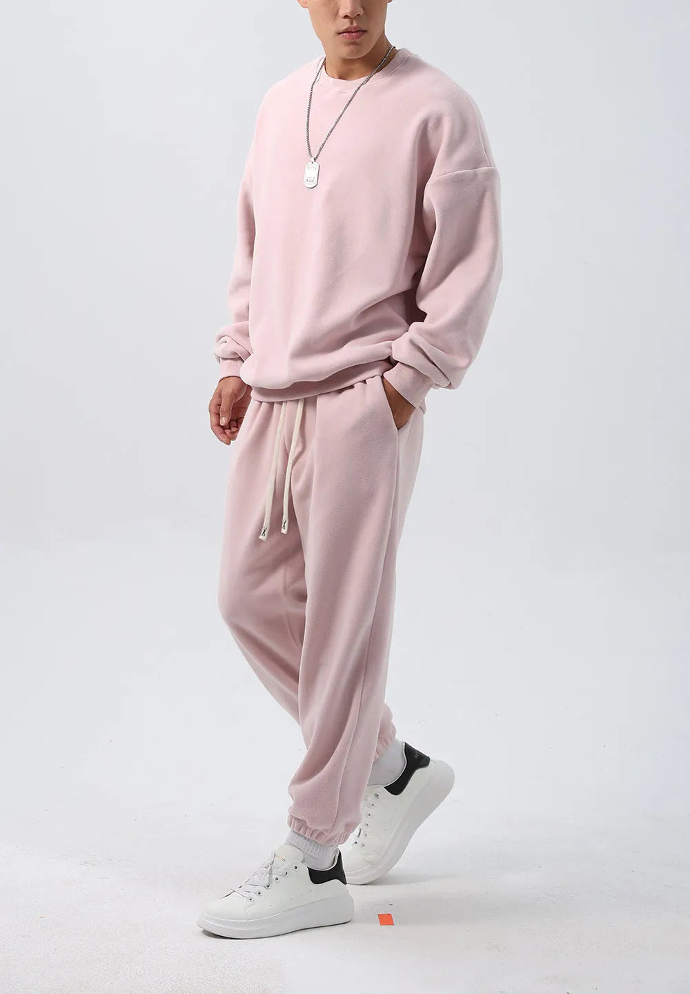 Men's polar fleece sports suit showing loose long sleeve coat and padded trousers in army green.