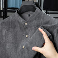 Men's solid colour linen shirt with a stand collar in a loose fit, shown in black grey.