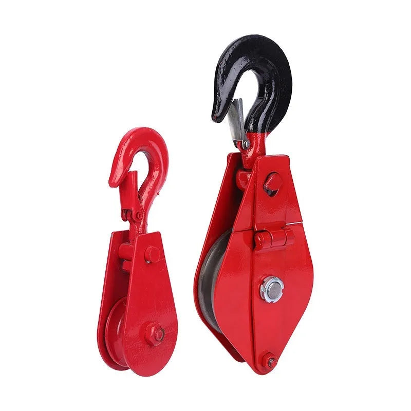 A small red industrial lifting pulley with a forged steel hook and safety latch.