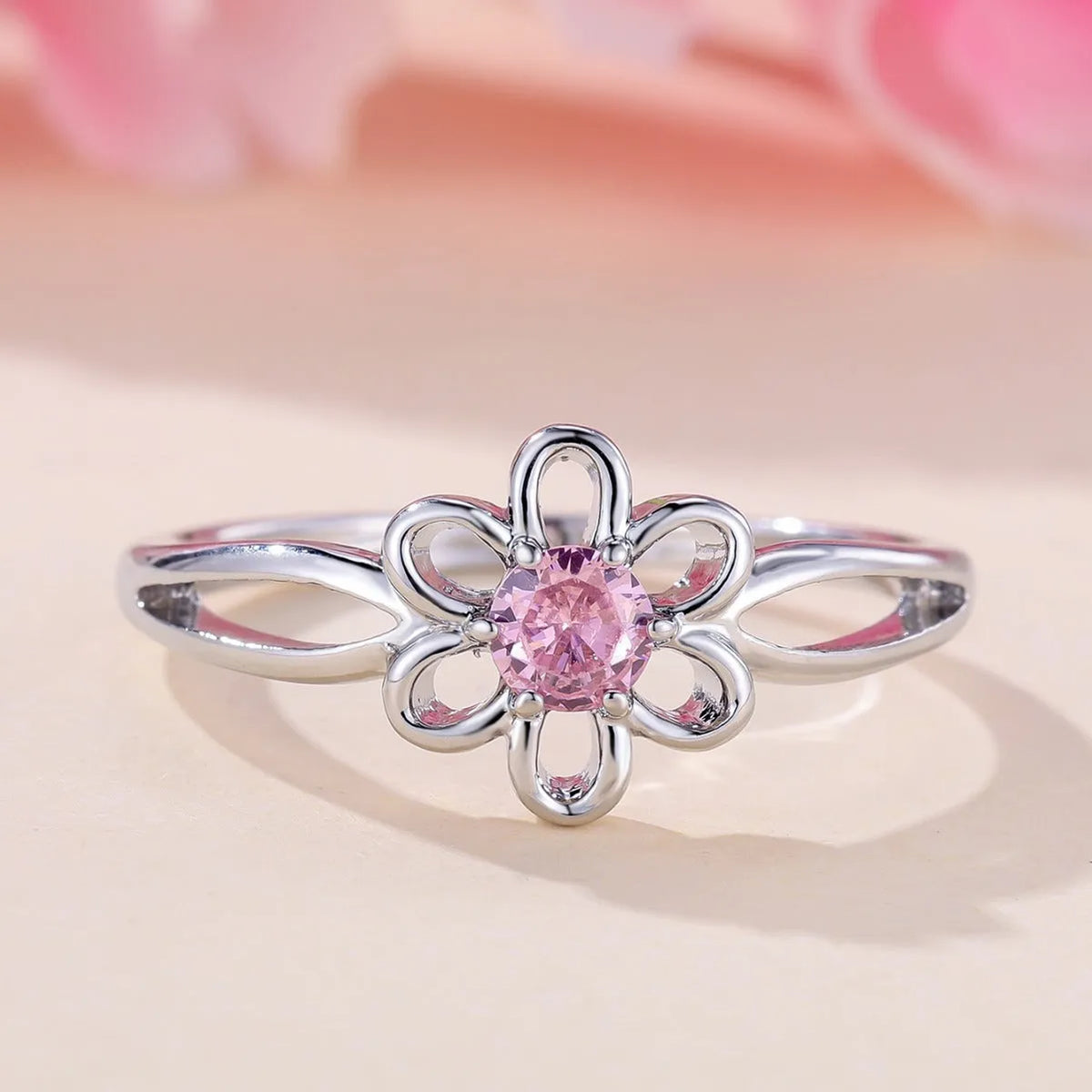 Women's hollowed floral copper ring with electroplated platinum pink diamond finish