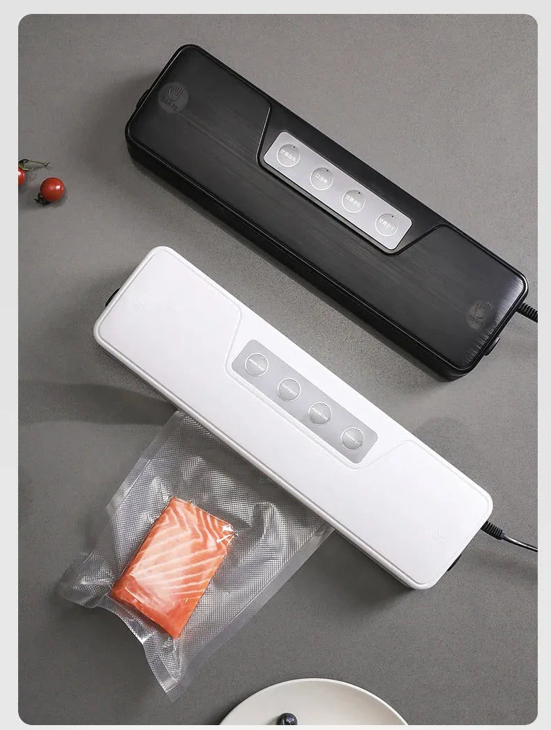 Small white automatic vacuum sealing machine for home food preservation on a kitchen counter.