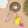 Grey and yellow retractable cat teaser toy hanging on door frame with treat bulb and dangling mouse