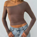 Women's slim fit knitted cardigan with cross shoulder straps in black, brown, or red.