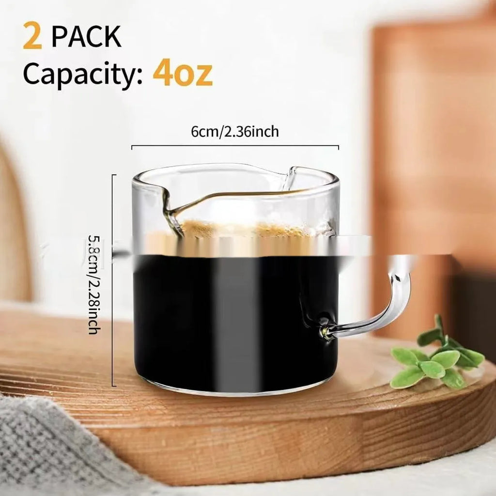 Transparent clear glass coffee cup with double spout design showing two drinking openings