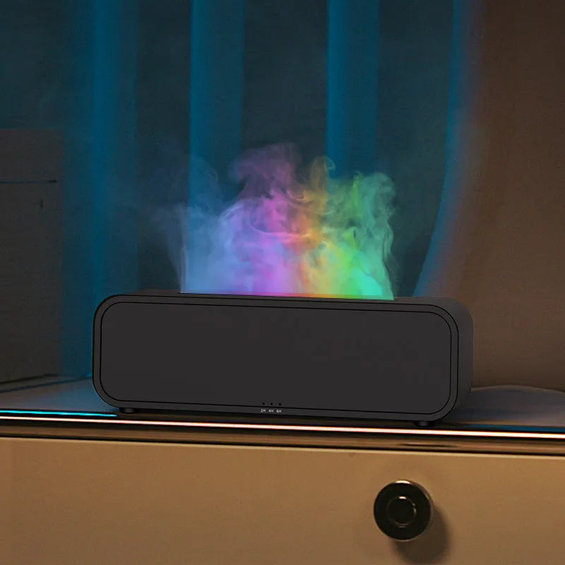 Black and white USB aroma diffuser with remote control and colour-changing lights on a wooden surface