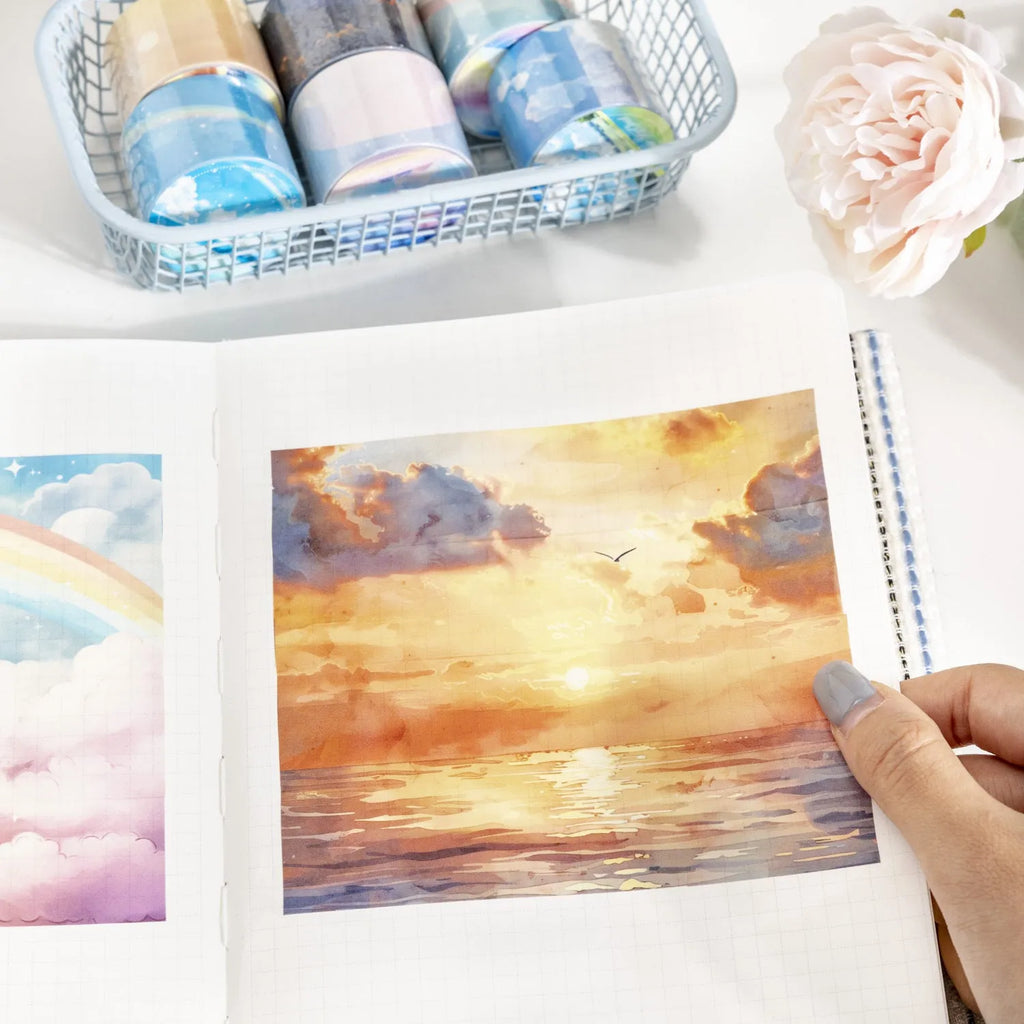 Roll of 30mm wide sky-themed Japanese paper washi tape showing colourful cloud design