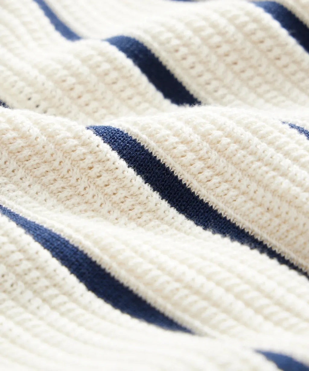 Men's white asymmetric knitted short sleeve top with lapel collar and striped pattern