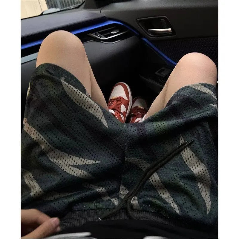 Men's camouflage pattern straight-leg mesh shorts on a plain background