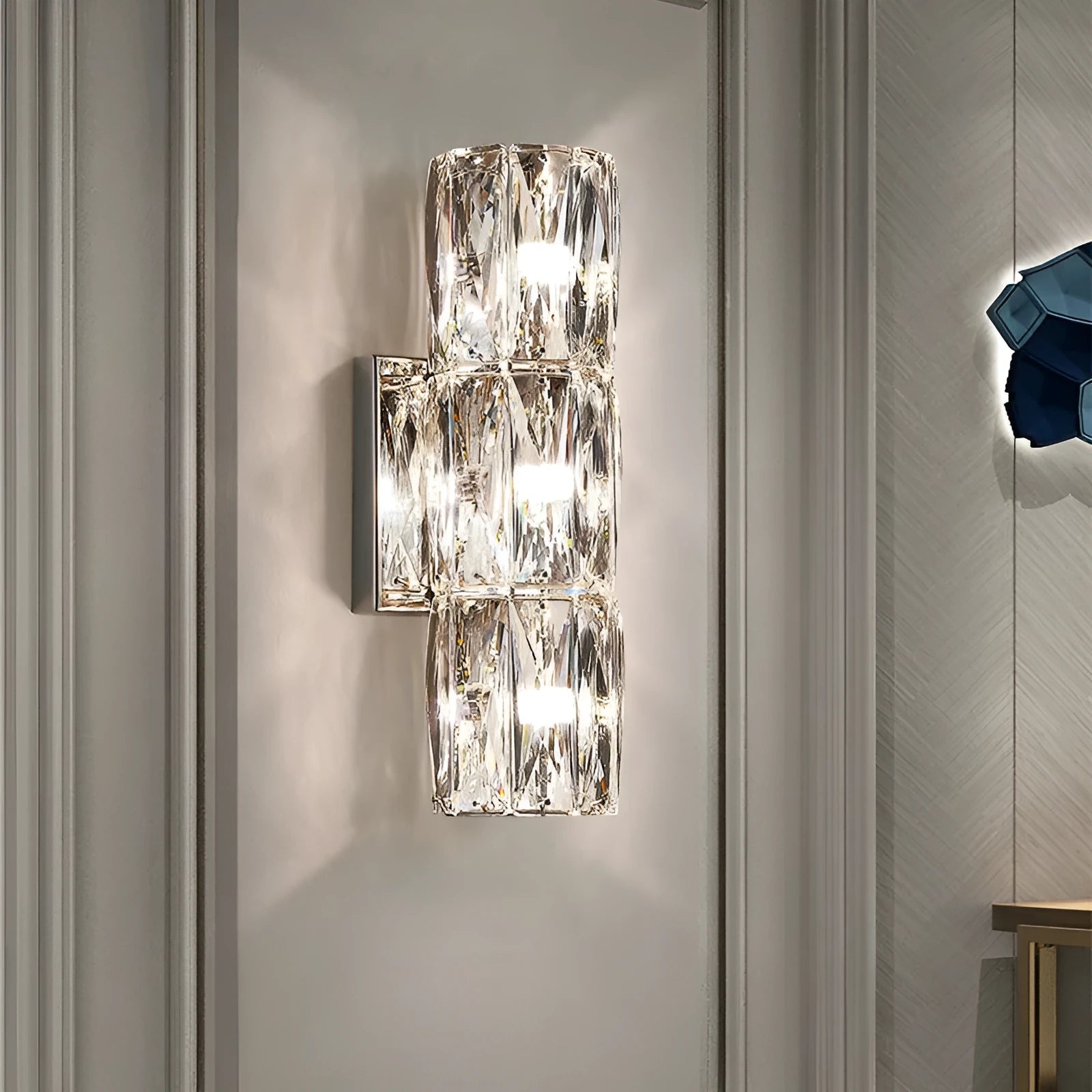 Crystal shade wall lamp with stainless steel body in chrome or gold finish, shown in multiple sizes.