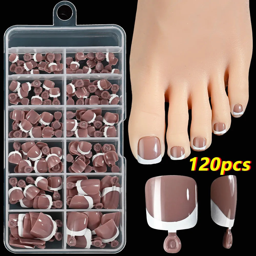 120 piece box of square short French style artificial toe nails with white tips on nude base.