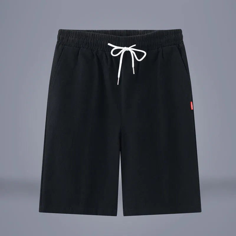 Man wearing solid colour cotton linen cropped trousers with a drawstring waist in a casual setting.